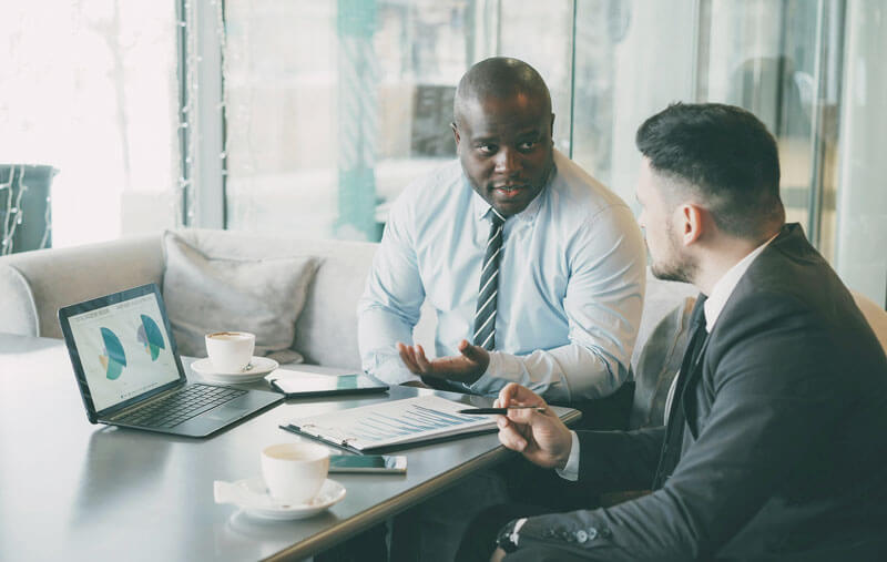 Two men discussing business in an office