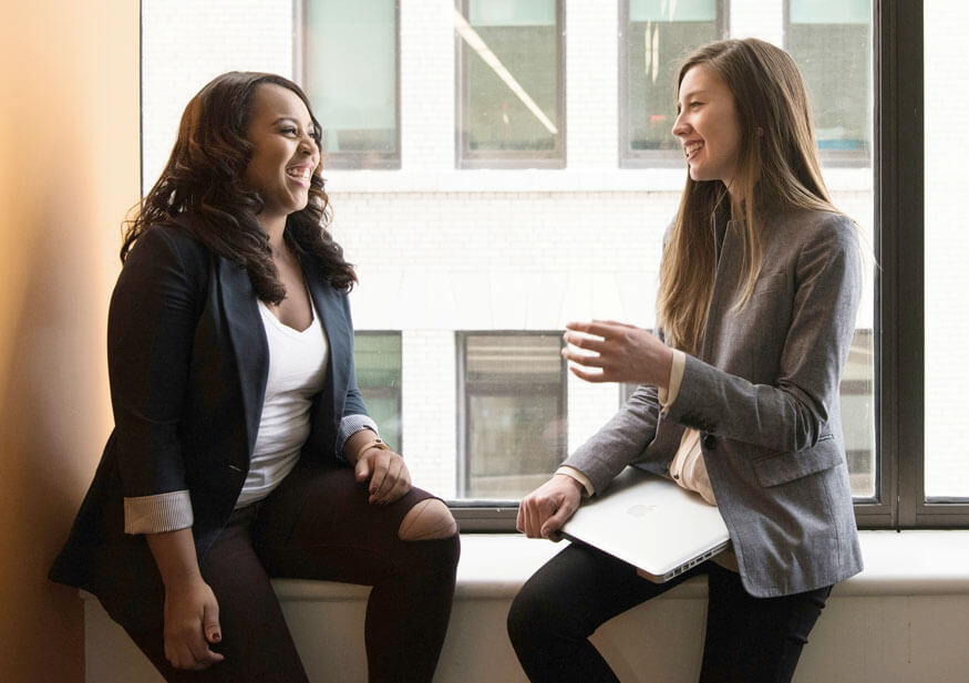 Two female business executives talking